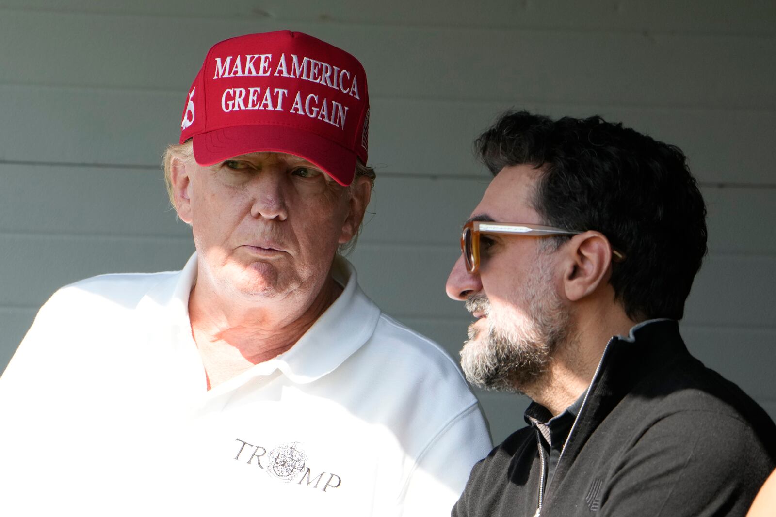 FILE - Former President Donald Trump talks with Yasir Al-Rumayyan, during the first round of the LIV Golf Tournament at Trump National Golf Club, in Sterling, Va., May 26, 2023. (AP Photo/Alex Brandon, File)