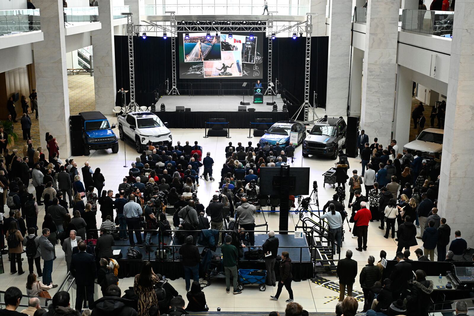 Michigan Gov. Gretchen Whitmer, on stage, speaks at the Detroit Auto Show, Wednesday, Jan. 15, 2025, in Detroit. (AP Photo/Jose Juarez)