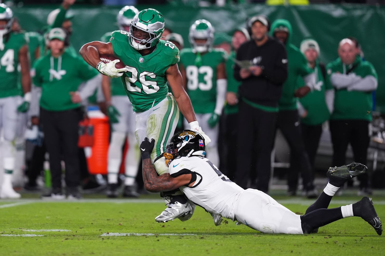 Philadelphia Eagles running back Saquon Barkley (26) runs with the ball while Jacksonville Jaguars safety Andre Cisco (5) tackles him during the second half of an NFL football game Sunday, Nov. 3, 2024, in Philadelphia. (AP Photo/Chris Szagola)