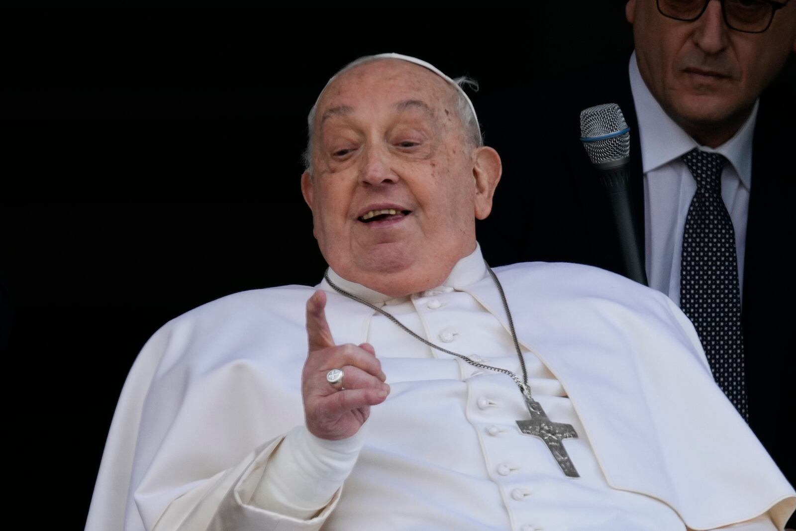 Pope Francis gestures as he appears at a window of the Agostino Gemelli Polyclinic in Rome, Sunday, March 23, 2025, where he has been treated for bronchitis and bilateral pneumonia since Feb. 14. (AP Photo/Domenico Stinellis)