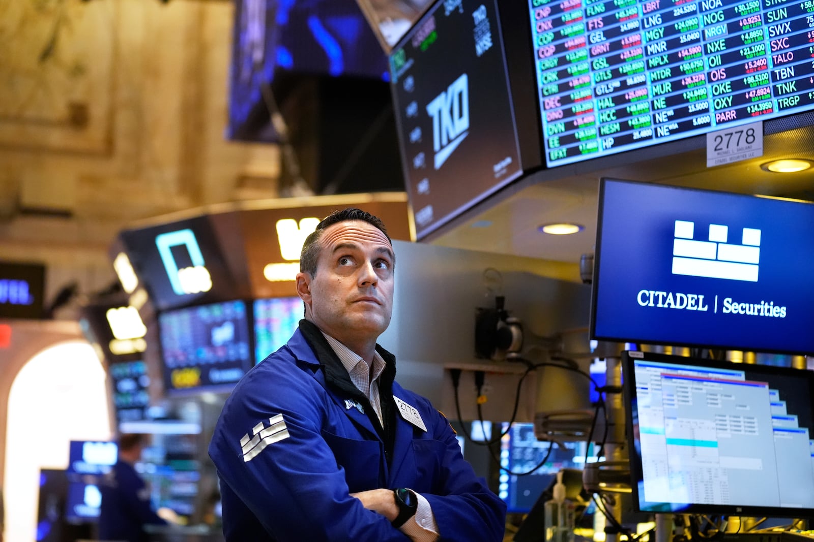 People work on the floor at the New York Stock Exchange in New York, Wednesday, March 19, 2025. (AP Photo/Seth Wenig)