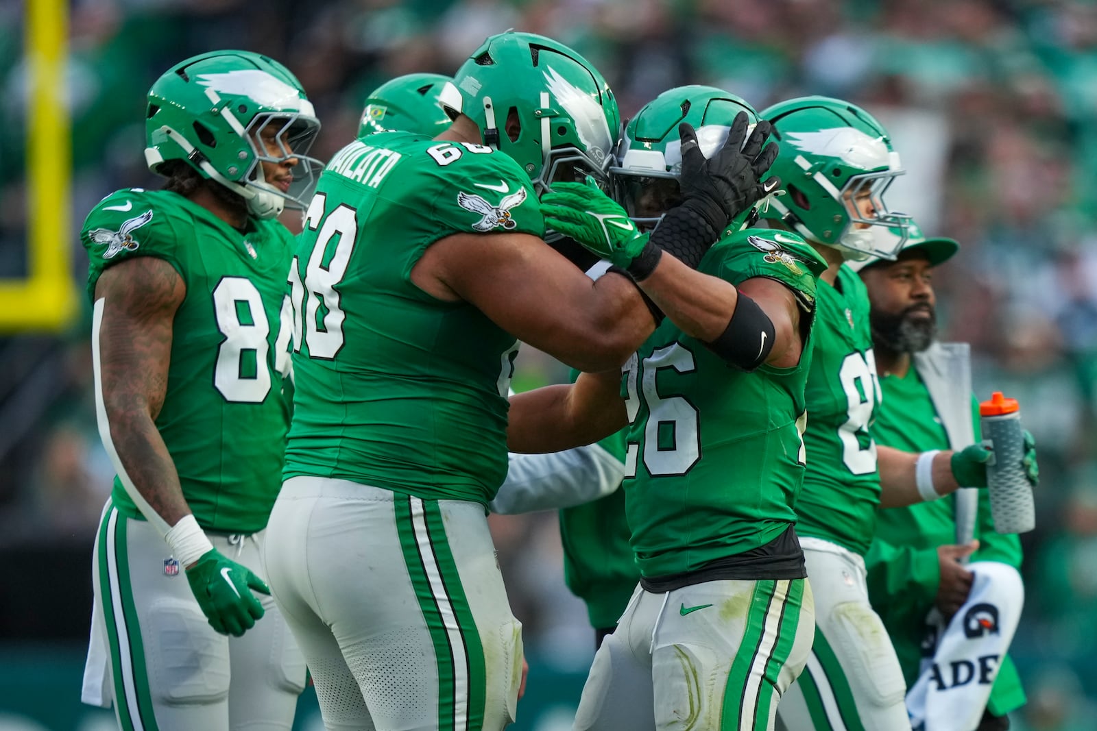 Philadelphia Eagles running back Saquon Barkley, right, is congratulated by offensive tackle Jordan Mailata after Barkley rushed for a long run to put him over 2,000 yards for the season during the second half of an NFL football game, Sunday, Dec. 29, 2024, in Philadelphia. (AP Photo/Matt Slocum)