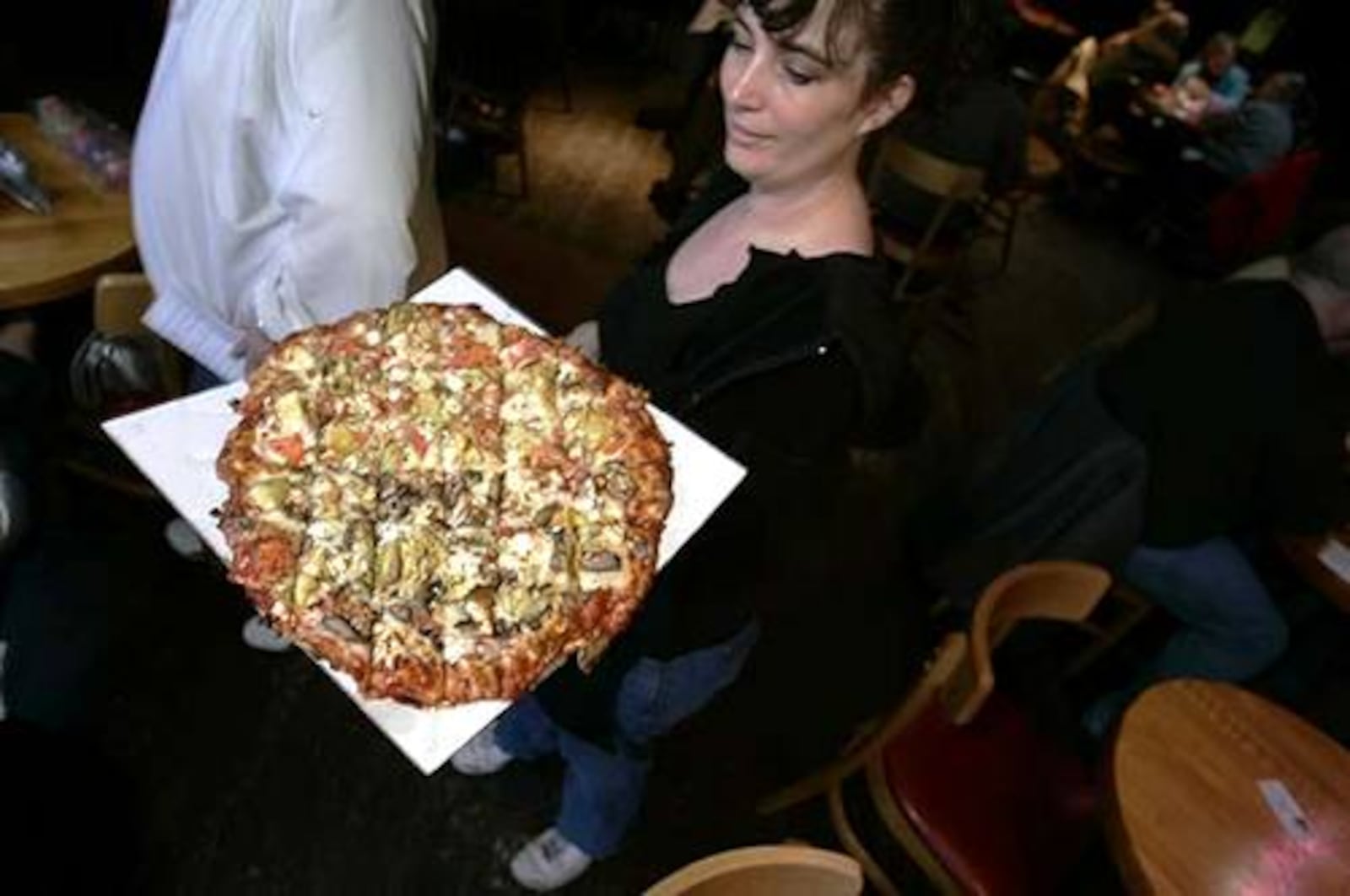 An Oregon Express waitress delivers pizza on in this file photo.