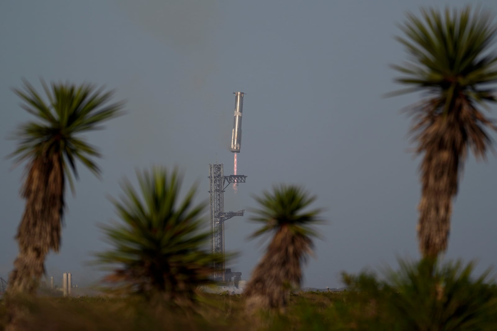 The booster of SpaceX's mega rocket Starship is recaptured during a test flight from Starbase in Boca Chica, Texas, Thursday, March 6, 2025. (AP Photo/Eric Gay)