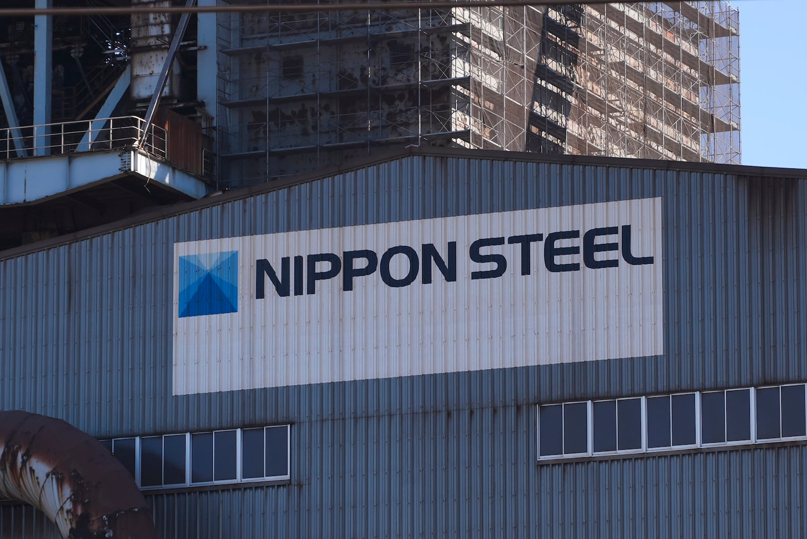 Logo of Nippon Steel on the exterior of Blast Furnace No. 1 at the company's Kashima Plant in Kashima, Japan on Friday, Dec. 6, 2024. (AP Photo/Ayaka McGill)