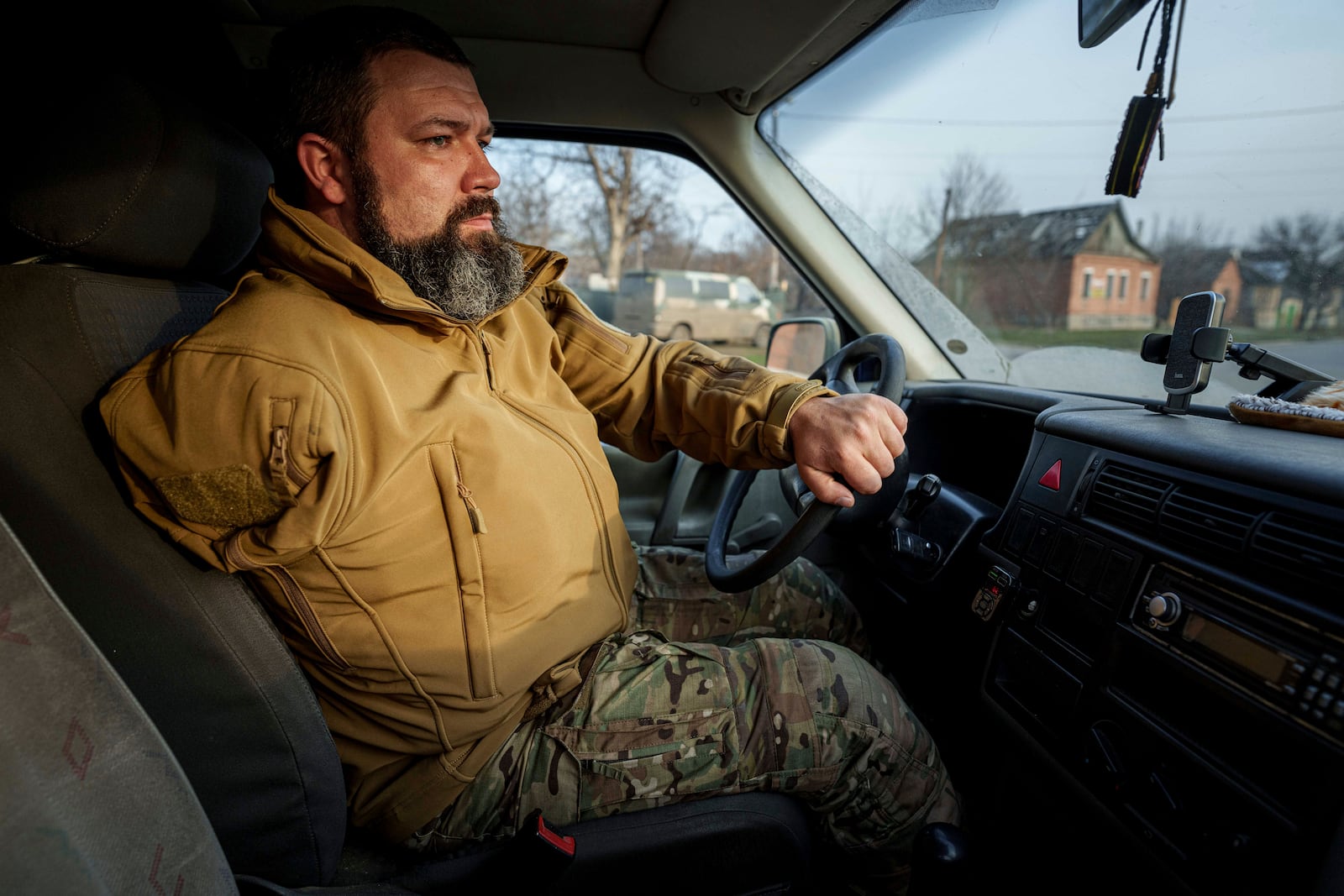 Ukrainian soldier Oleksandr Zhalinskyi of the Azov brigade, who lost his right arm in battle, drives a car in Ukraine's Donetsk region on Jan. 31, 2025. (AP Photo/Evgeniy Maloletka)