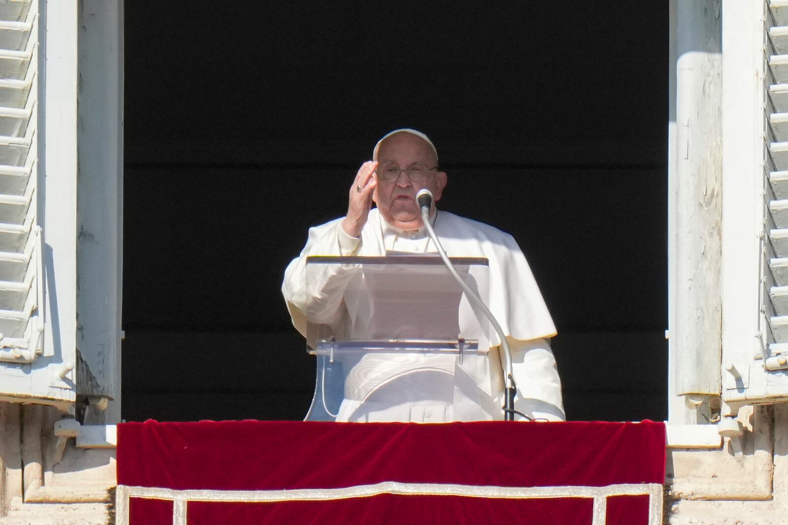 Pope Francis appears at his studio's window overlooking St. Peter's Square at The Vatican to bless pilgrims and faithful after presiding over a mass in St. Peter's Basilica on New Year's Day, Wednesday, Jan. 1, 2025. (AP Photo/Andrew Medichini)