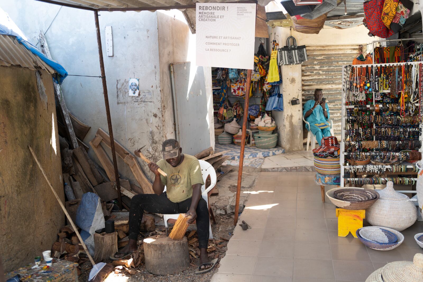 Woodcarver Papis Kanté sculpts a wooden hippopotamus to be exhibited in the "Rebondir" exhibition as part of the Dakar 2024 Biennial Off in Dakar, Senegal, Thursday, Nov. 28, 2024. (AP Photo/Sylvain Cherkaoui)