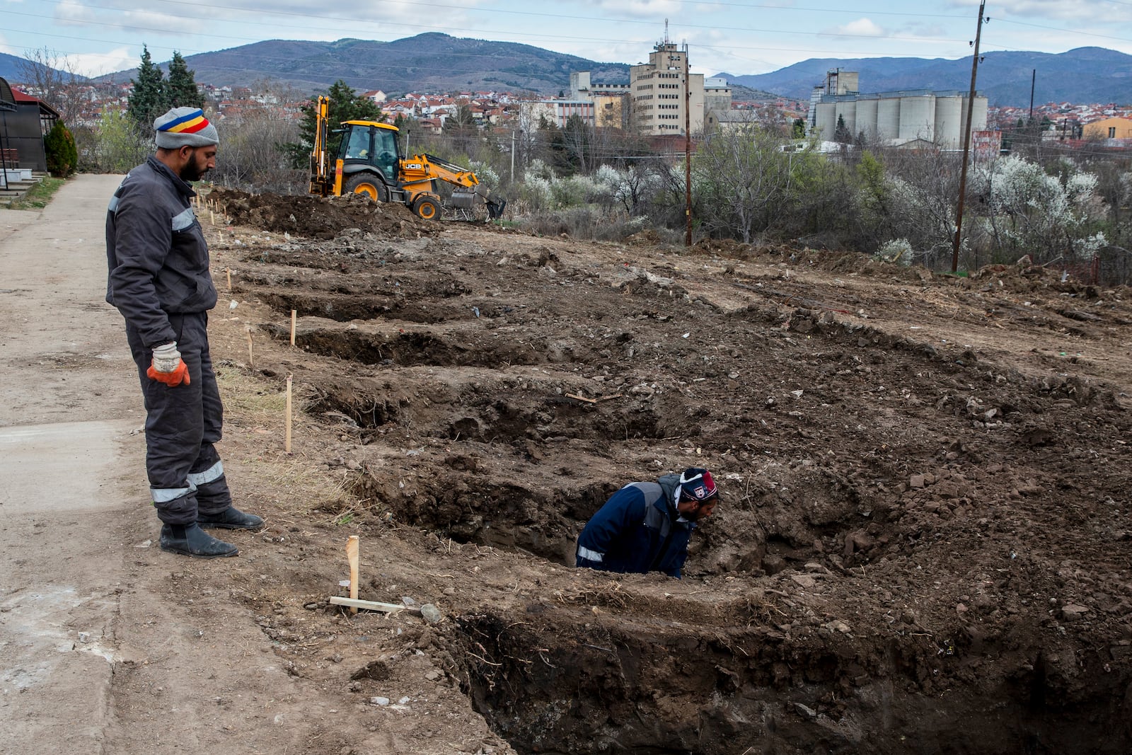 Workers dig graves for the victims of a massive nightclub fire in the town of Kocani, North Macedonia, Tuesday, March 18, 2025. (AP Photo/Visar Kryeziu)