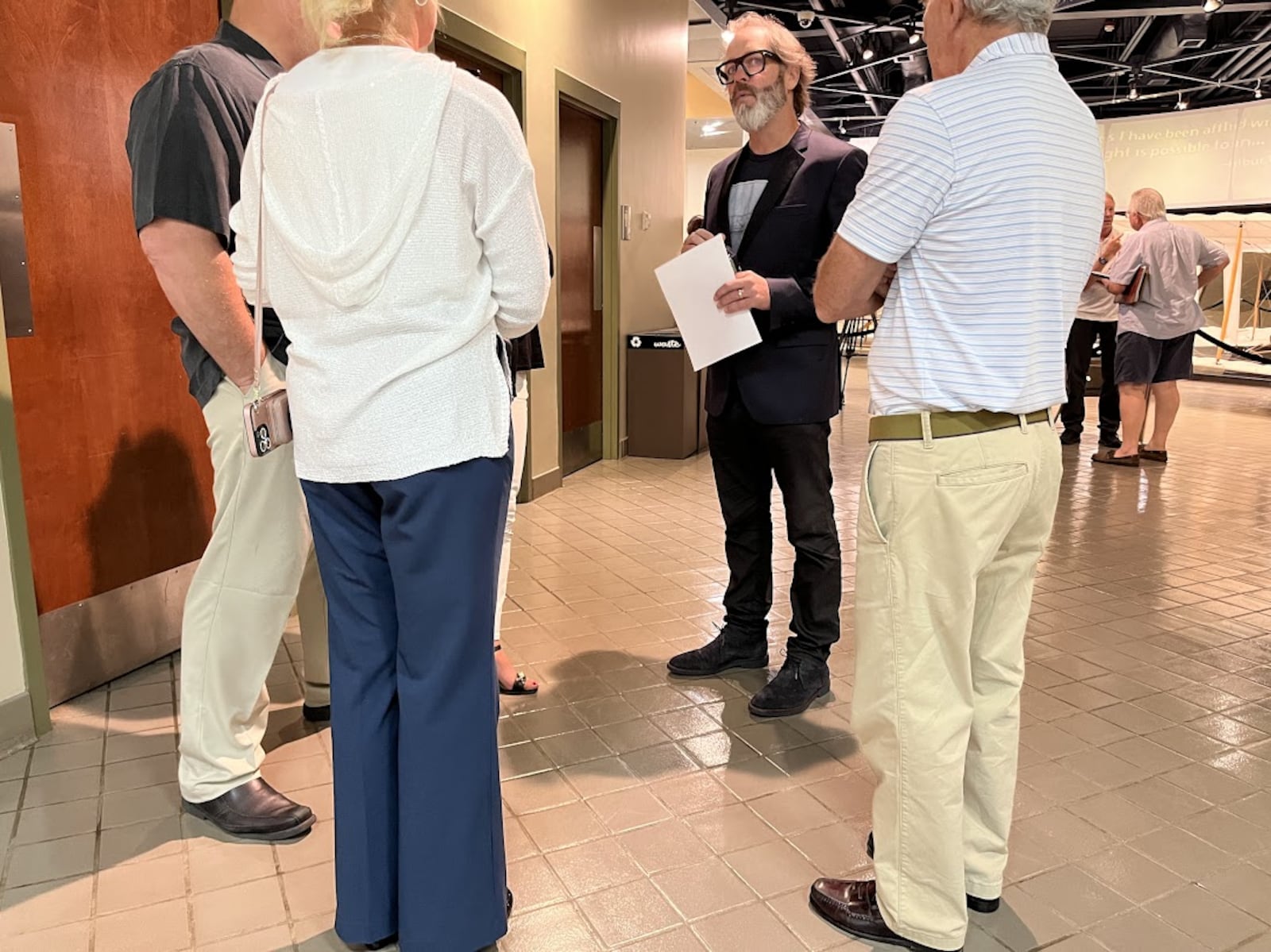 Allen Farst, second from the right, speaking with friends Tuesday at the offices of the Dayton Aviation Heritage National Historical Park. THOMAS GNAU/STAFF