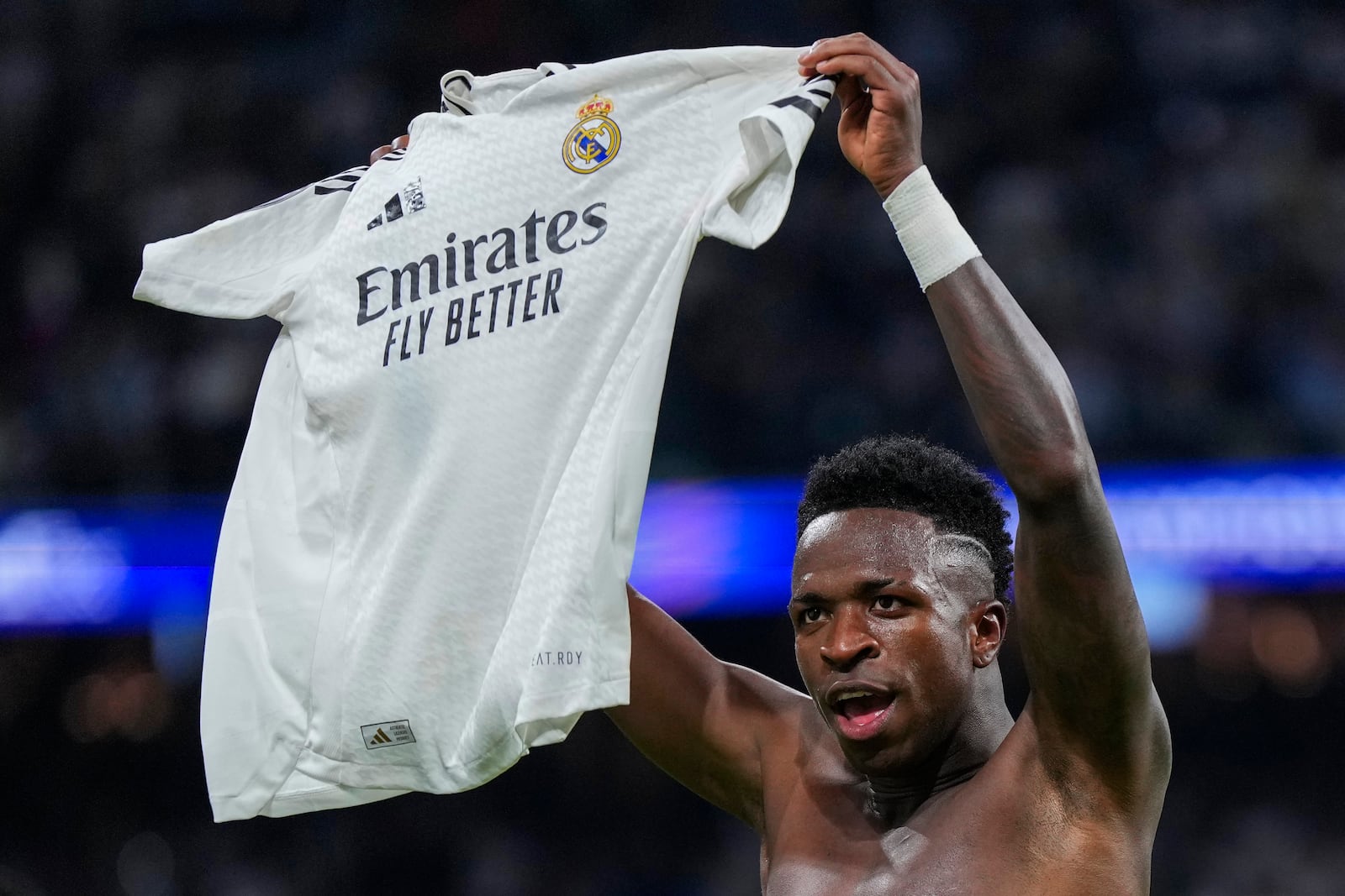 Real Madrid's Vinicius Junior celebrates after scoring his side's fourth goal during the Champions League opening phase soccer match between Real Madrid and Borussia Dortmund at the Santiago Bernabeu stadium in Madrid, Tuesday, Oct. 22, 2024. Vinicius scored a hat-trick in Real Madrid's 5-2 victory. (AP Photo/Manu Fernandez)