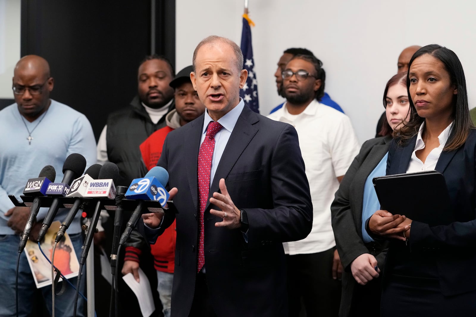 Jerome Block, partner, Levy & Konigsberg LLP, center, talks to media as attorney Kristen Feden, right, listens during a news conference in Chicago, Tuesday, Feb. 11, 2025. (AP Photo/Nam Y. Huh)