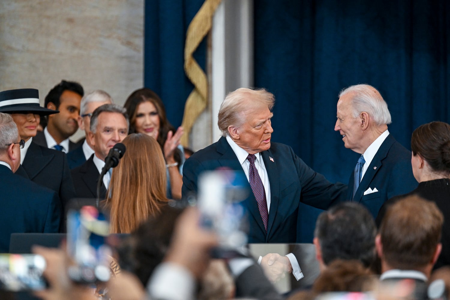 President-elect Donald Trump, center, greets President Joe Biden as he arrives at his inauguration as the 47th president in the Rotunda at the Capitol in Washington on Monday morning, Jan. 20, 2025. (Kenny Holston/The New York Times)