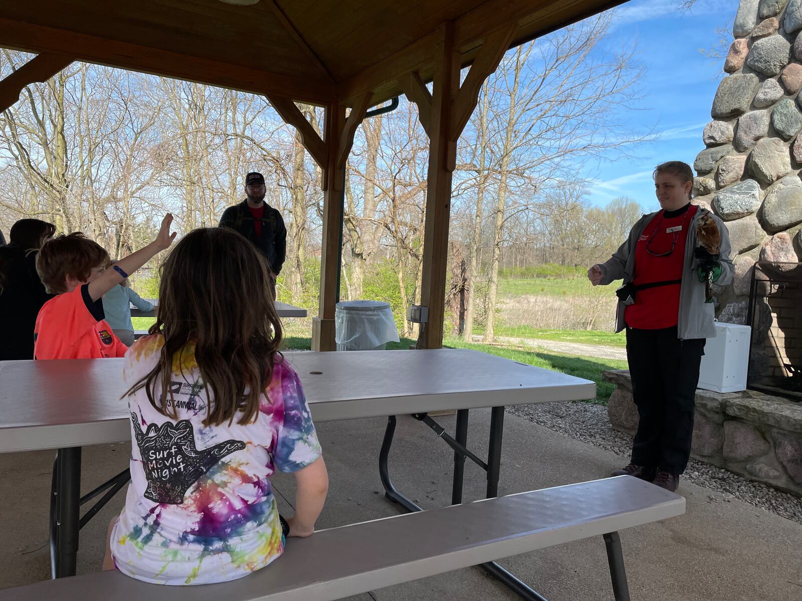 Robbie and Poppy Sieffert watch a presentation about screech owls at Aullwood Audubon in Dayton on Monday, April 8, 2024. NATALIE JONES/STAFF