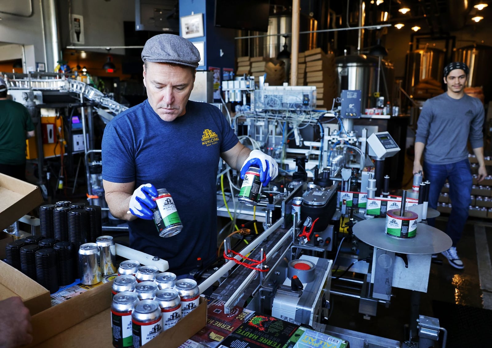 Jim Goodman, with Municipal Brew Works, mans the canning line Tuesday, March 19, 2024. Municipal Brew Works spent the day canning several beers including their new Path of Totality German Altbier brewed to celebrate the upcoming solar eclipse. NICK GRAHAM/STAFF