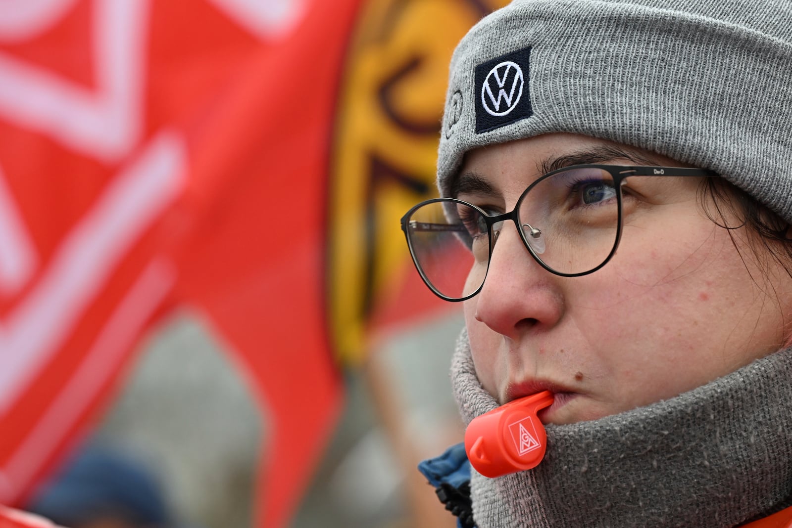 A Volkswagen worker blows a whistle on the first day of a nationwide warning Volkswagen workers' strike, outside a Volkswagen plant in Zwickau, Germany, Monday, Dec. 2, 2024. (Hendrik Schmidt/dpa via AP)