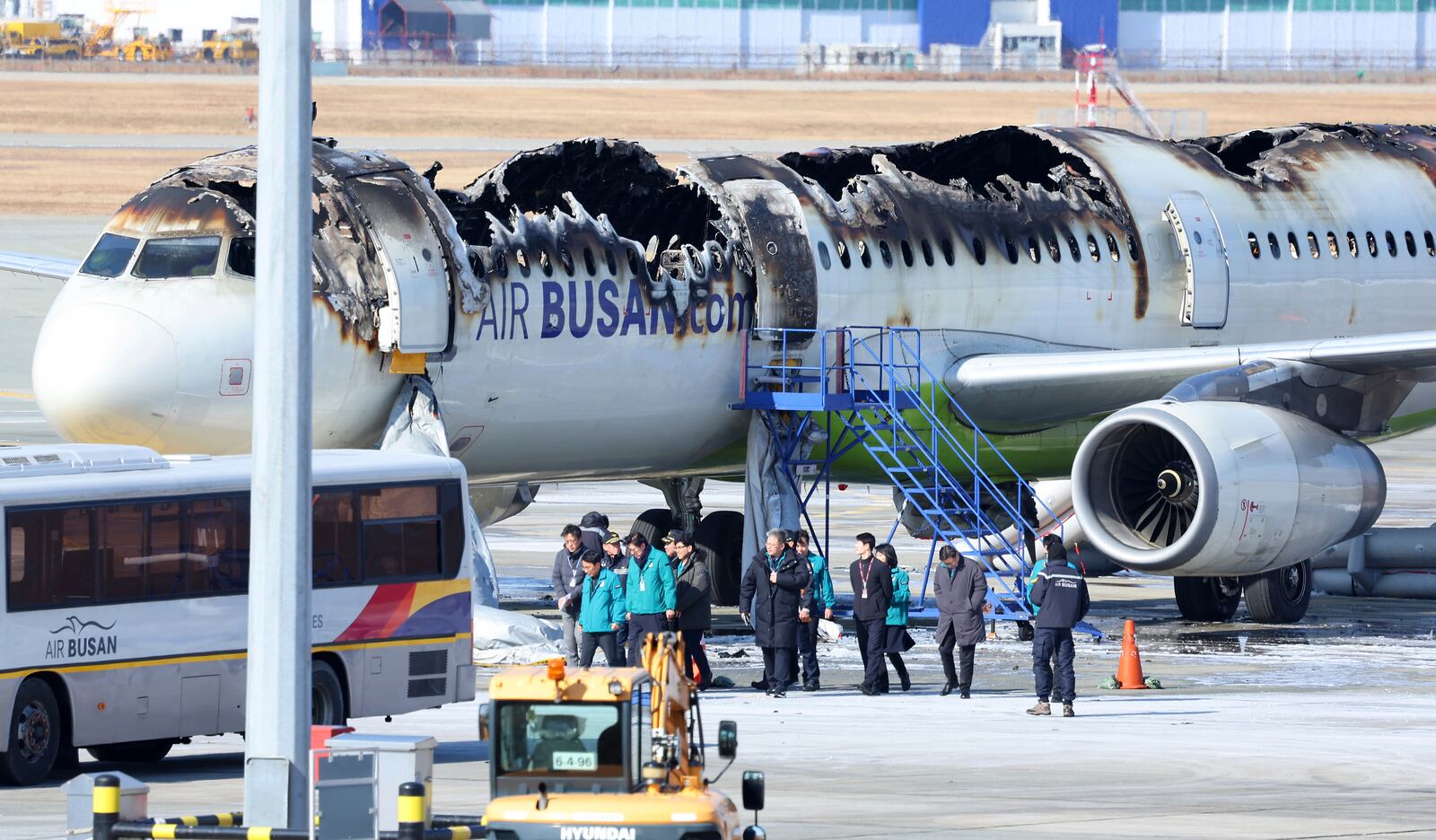 Mayor of Busan Park Heong-joon and other officials visit the site where an Air Busan airplane caught fire at Gimhae International Airport in Busan, South Korea, Wednesday, Jan. 29, 2025. (Son Hyung-joo/Yonhap via AP)