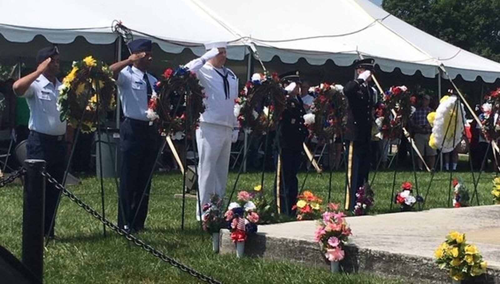 Members of various military branches salute wreaths during the playing of “Taps” during the Memorial Day ceremonies at the Dayton National Cemetery Monday. NICK BLIZZARD