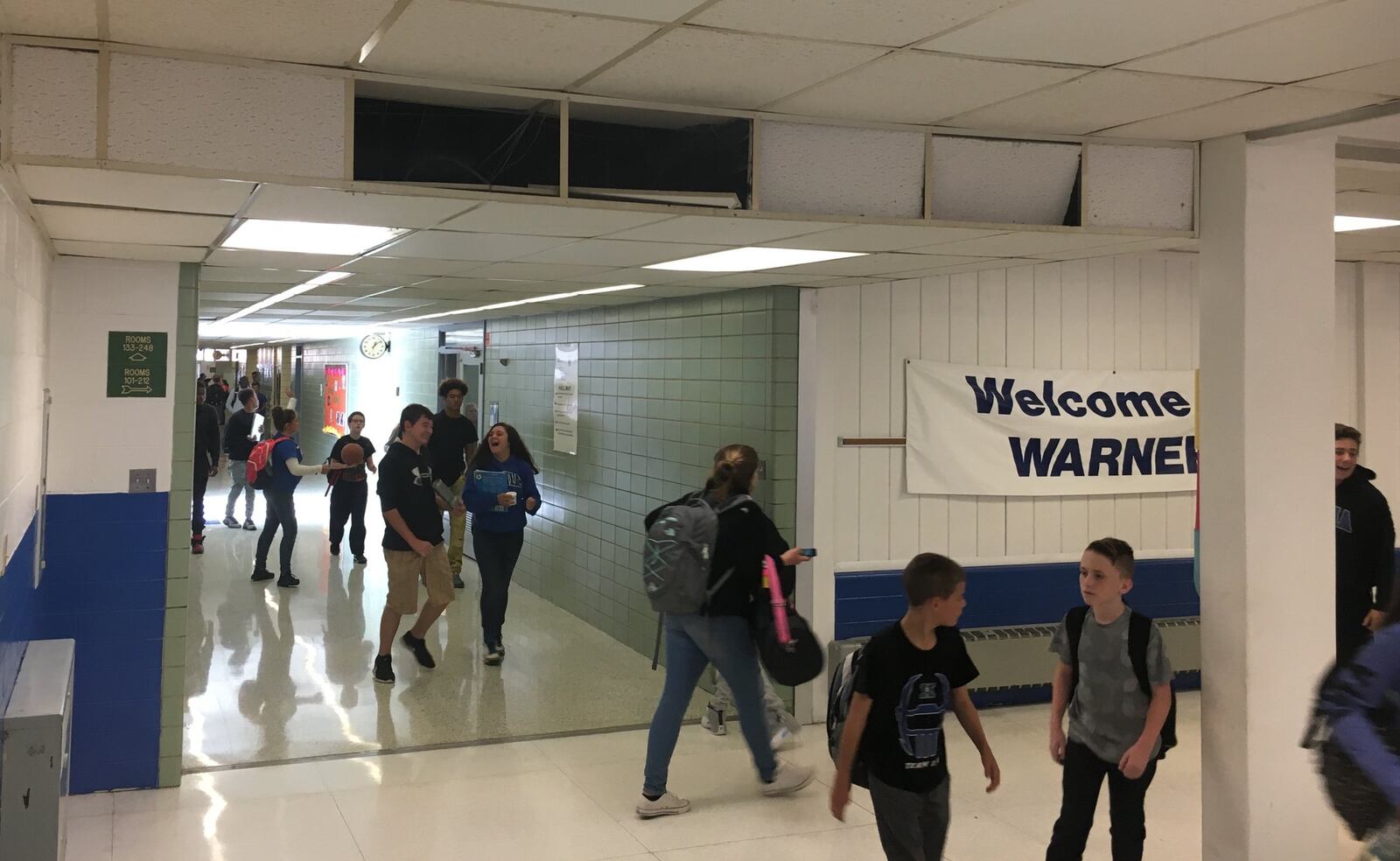 Students at Warner Middle School in Xenia walk past outdated heating vents, nonworking clocks and damaged ceilings last month. JEREMY P. KELLEY / STAFF