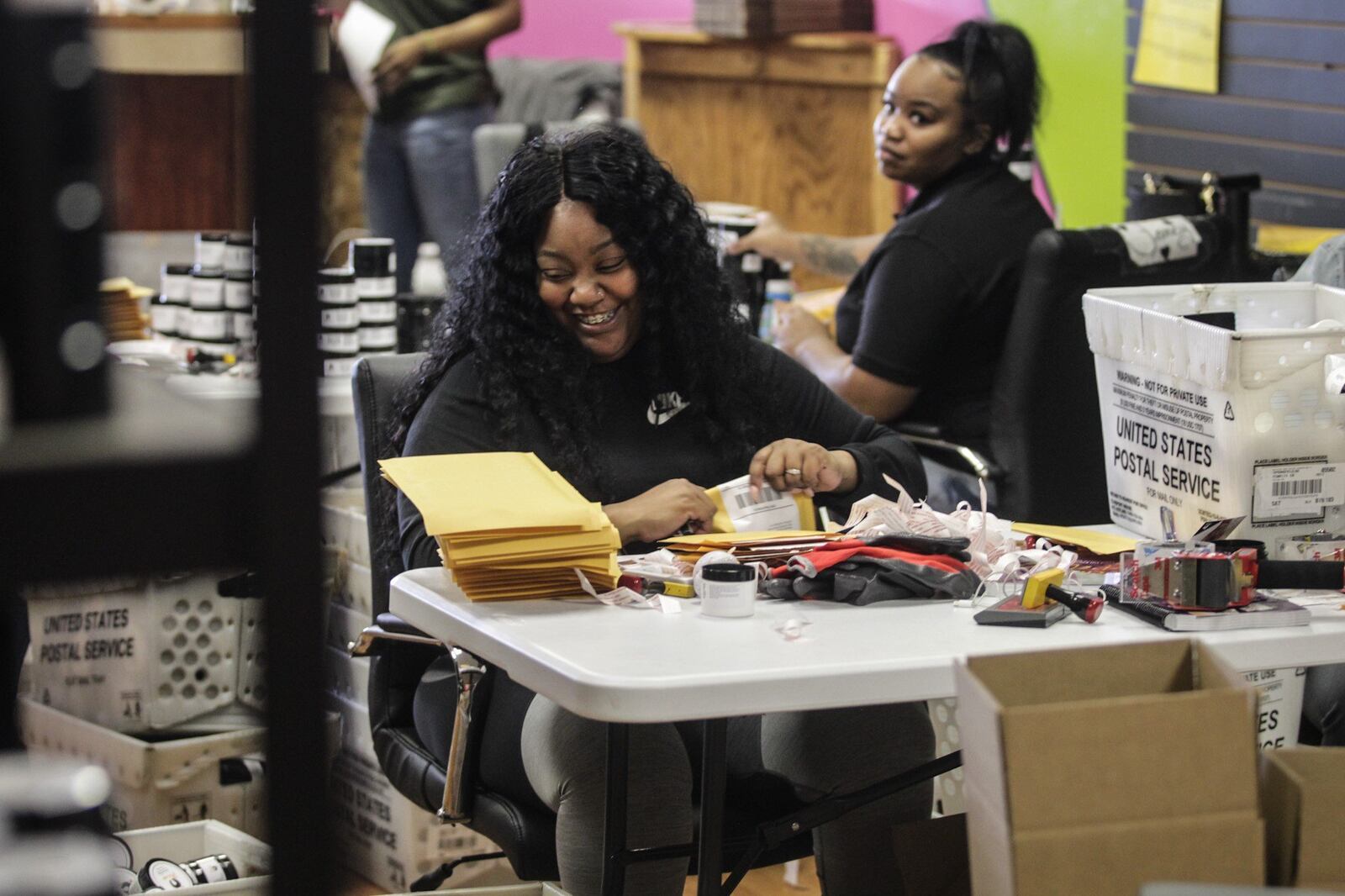 Jerricha Hoskins (left), owner of Arcani Coil Care loads boxes of her hair care products for shipping. Hoskins started her business in 2017 and distributes products from her warehouse on Salem Ave. JIM NOEKLER/STAFF JIM NOELKER/STAFF