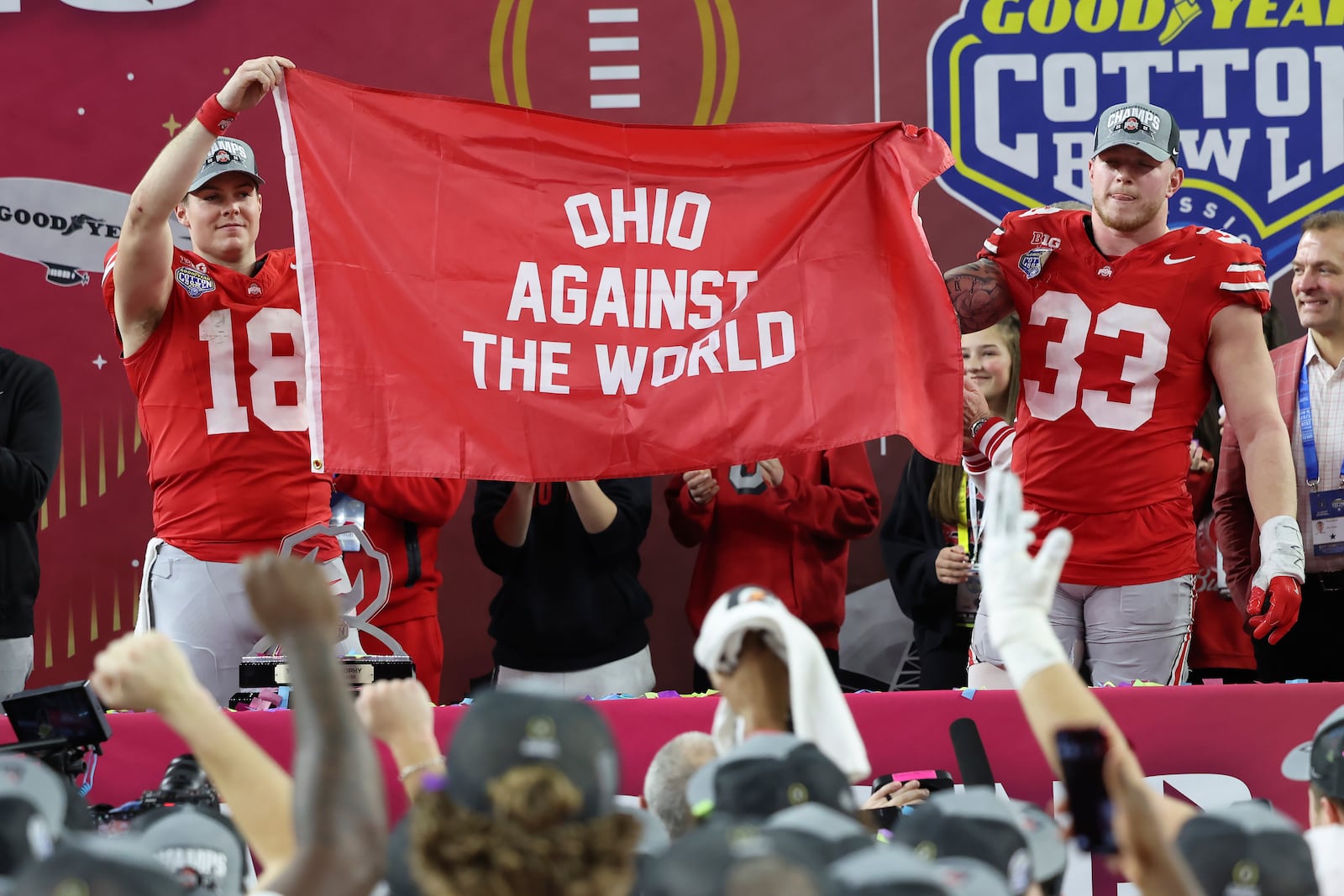 Ohio State quarterback Will Howard (18) and defensive end Jack Sawyer (33) celebrate after the Cotton Bowl College Football Playoff semifinal game against Texas, Friday, Jan. 10, 2025, in Arlington, Texas. (AP Photo/Gareth Patterson)