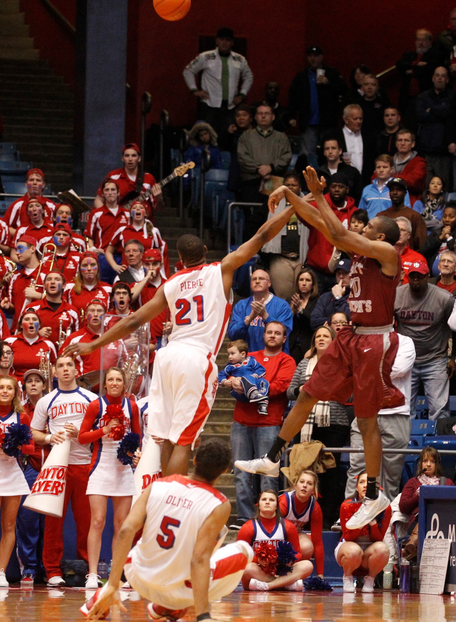 Langston Galloway, of Saint Joseph's, hits a 3-pointer over Dayton's Dyshawn Pierre with 1 second left to beat the Flyers 60-57 on Wednesday, Jan. 29, 2014, at UD Arena. Devin Oliver watches the shot from the foreground. David Jablonski/Staff