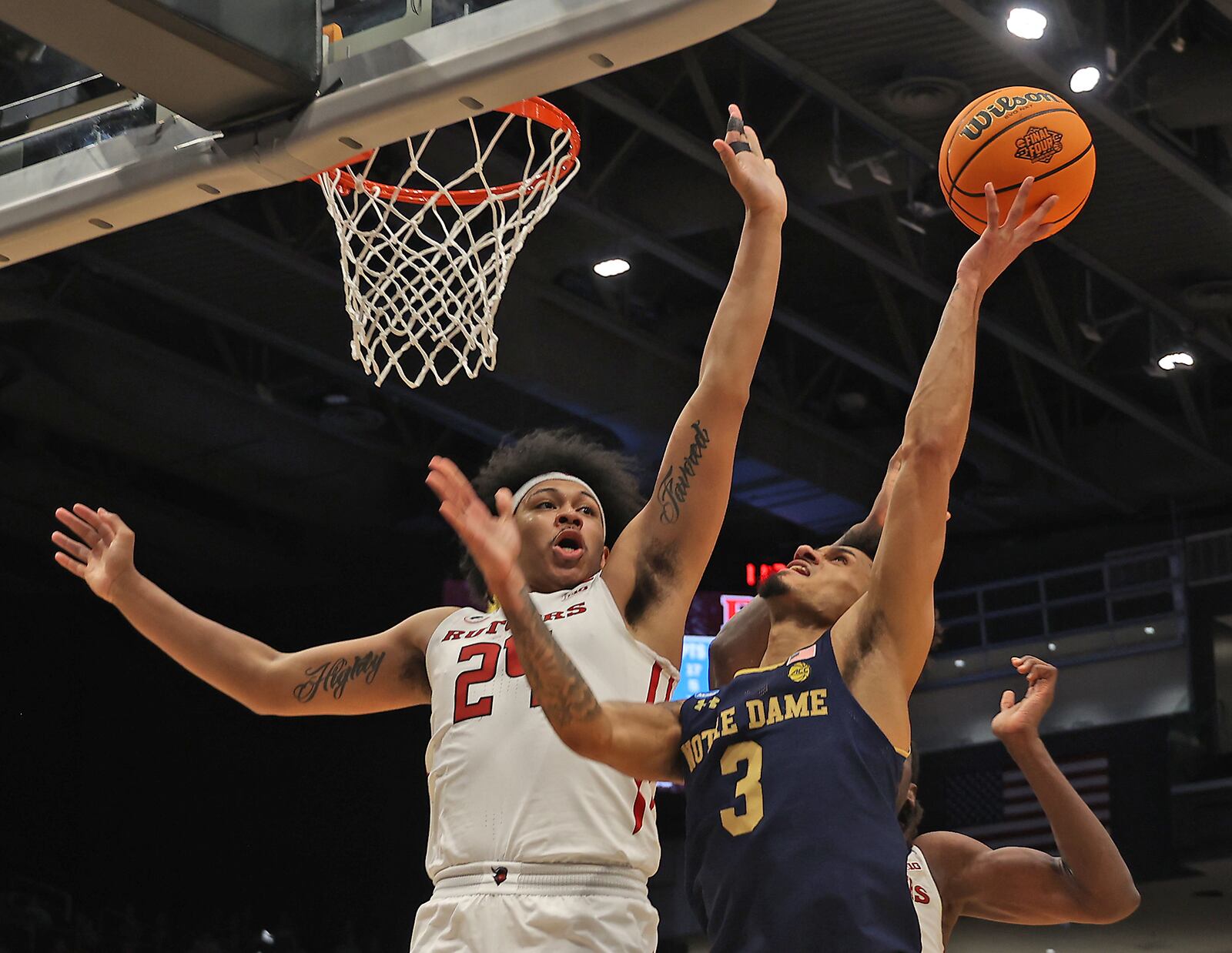 Rutgers Ron Harper blocks a shot by Notre Dame's Prentiss Hubb during their First Four game at UD Arena Wednesday, March 16, 2022. BILL LACKEY/STAFF