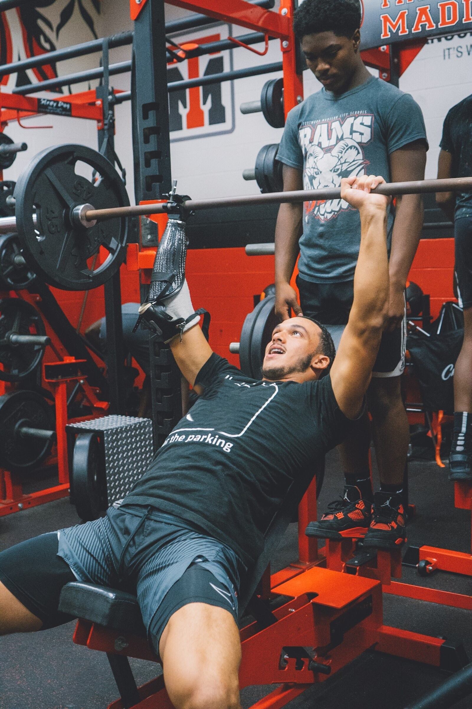 With his right arm fitted with a prosthetic clamp, Issiah Evans works out in the weight room at Trotwood-Madison High School. CONTRIBUTED