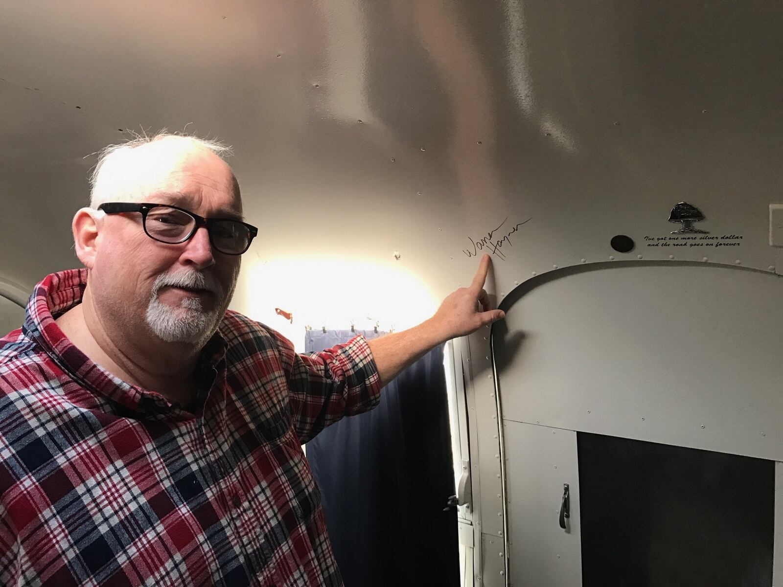 Dean Gillispie in the Airstream trailer he rebuilt, pointing to the autograph by Warren Haynes, the longtime Allman Brothers guitarist and Government Mule founder whose song Soulshine he penned for the Allman Brothers became the anthem that Gillispie said that helped get him through his wrongful 20 year prison stint.
Tom Archdeacon/CONTRIBUTED