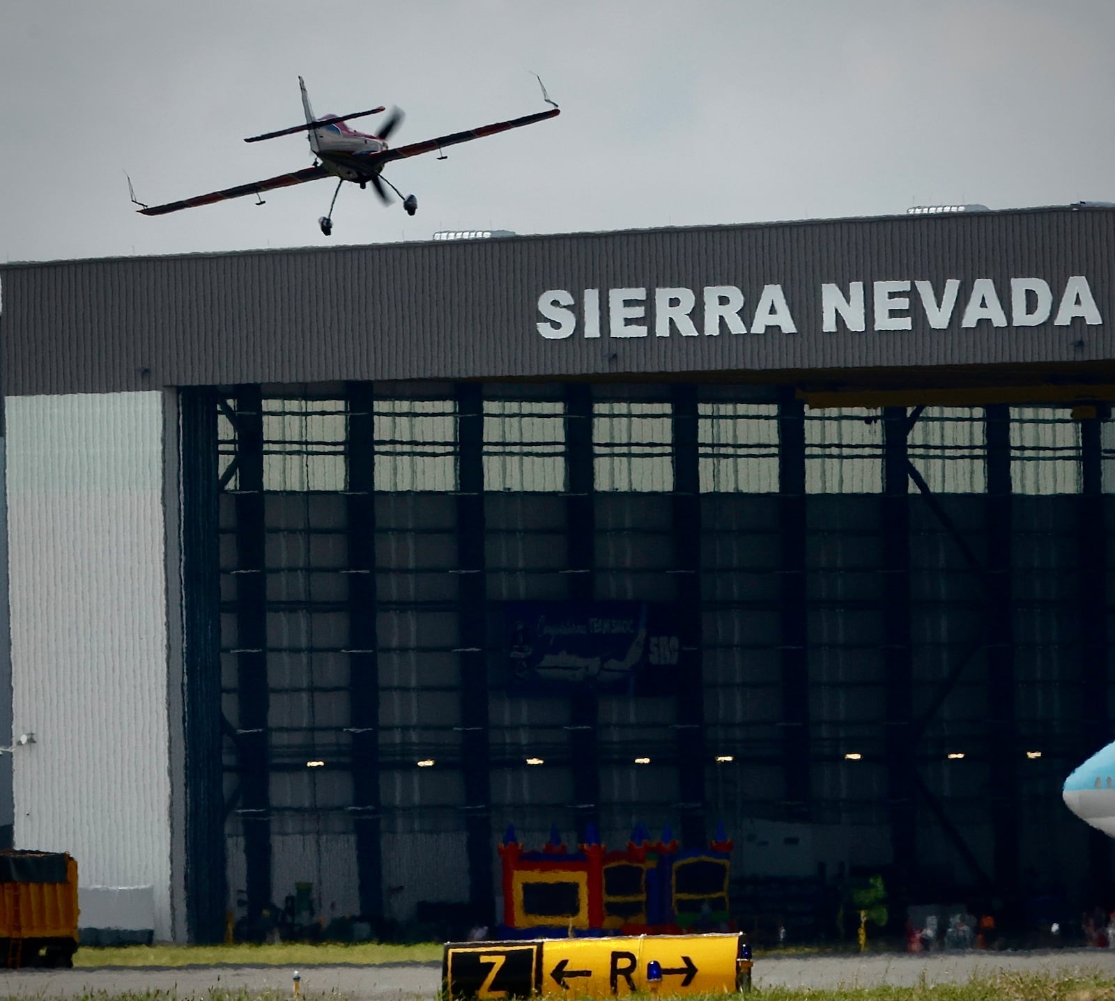 Rob Holland makes a low pass by the Sierra Nevada hangar at the Dayton Air Show on Sunday, June 23, 2024. MARSHALL GORBY / STAFF