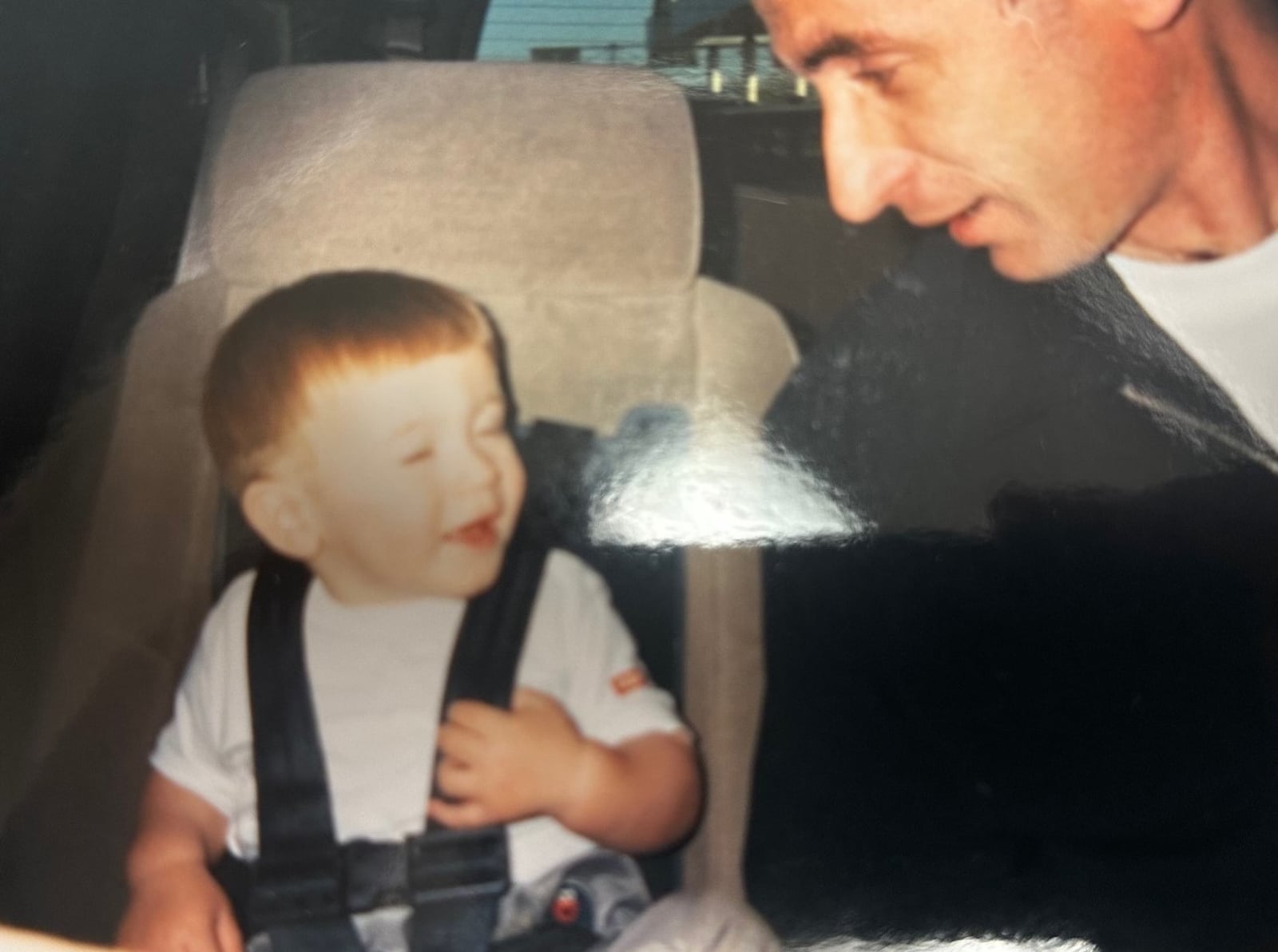 Mo Jusufi with his son, Albert, as they are coming from the airport the day he arrived in Dayton from a refugee camp in Holland in 2002. Today, Albert is 23 and graduated from Wright State in December 2023. CONTRIBUTED