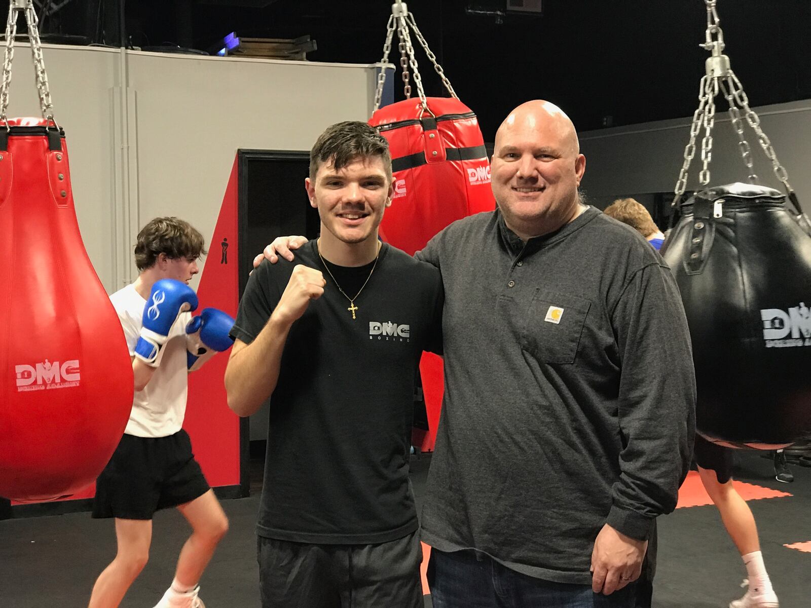 Liam Walsh and his dad Jason  at the DMC Boxing Academy in Centerville Monday night. Tom Archdeacon/CONTRIBUTED