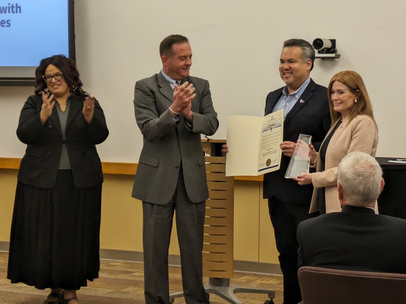 Opportunities for Ohioans with Disabilities director Kevin L. Miller (middle left) recognizes Erhardt Preitauer, president and CEO of CareSource (middle right), and Jennifer Dougherty, chief human resources officer at CareSource (far right), with the 2023 Governor’s Inclusive Employer Award during an event on Thursday, Oct. 26, at CareSource's corporate office. Crown Equipment Corporation also received a 2023 Governor’s Inclusive Employer Award. SAMANTHA WILDOW\STAFF