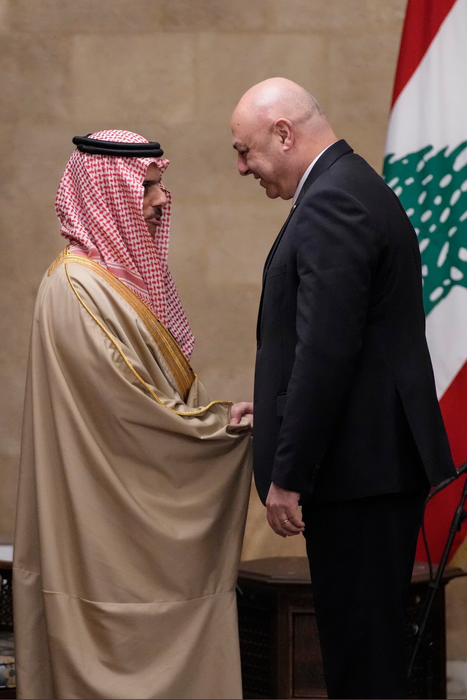 Lebanese President Joseph Aoun, right, shakes hands with Saudi Arabia's Foreign Minister Prince Faisal bin Farhan al-Saud at the presidential palace in Baabda, east of Beirut, Lebanon, Thursday, Jan. 23, 2025. (AP Photo/Hassan Ammar)