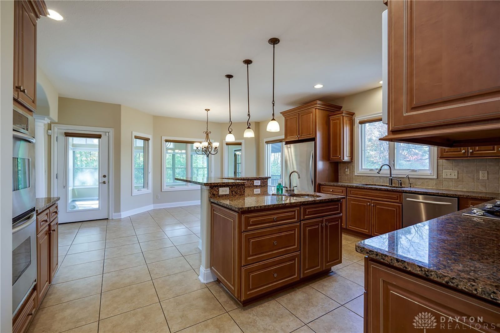 The kitchen has gourmet style appliances including a gas cooktop, an island, granite countertops and a walk in pantry.