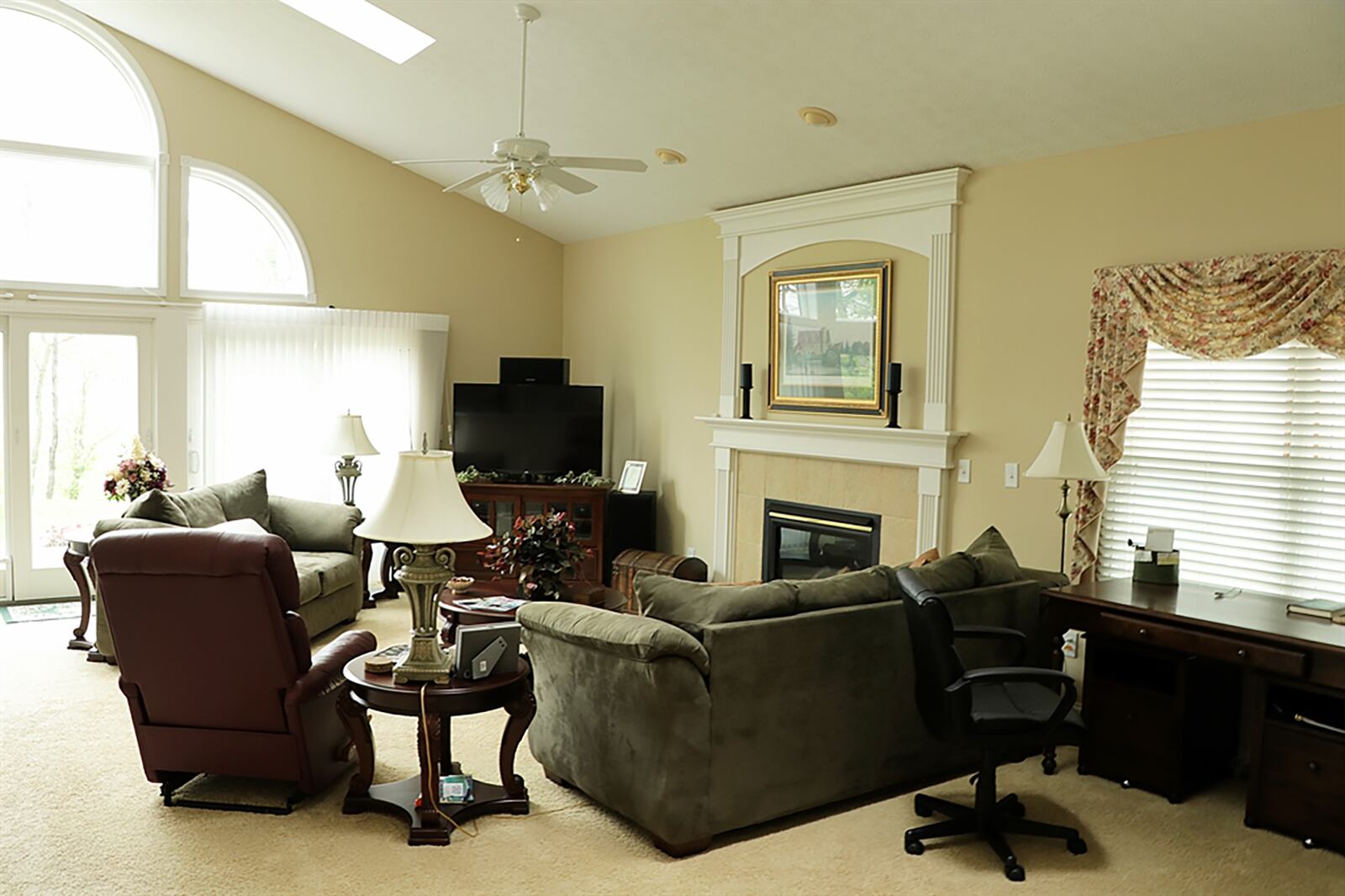 A peninsula counter divides the kitchen from the great room as a cathedral ceiling peaks over the three main social areas. The great room has a gas fireplace with a double fluted wood mantel and ceramic-tile surround. CONTRIBUTED PHOTO BY KATHY TYLER