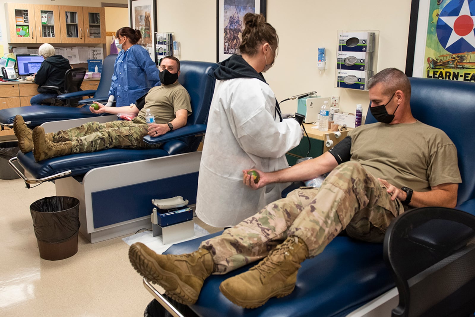 Chief Master Sgt. Joe Newton (right), 88th Mission Support Group command chief, and Chief Master Sgt. Donald Valentine, 88th Communications Group command chief, donate blood during a drive Oct. 19 at Wright-Patterson Air Force Base. U.S. AIR FORCE PHOTO/WESLEY FARNSWORTH