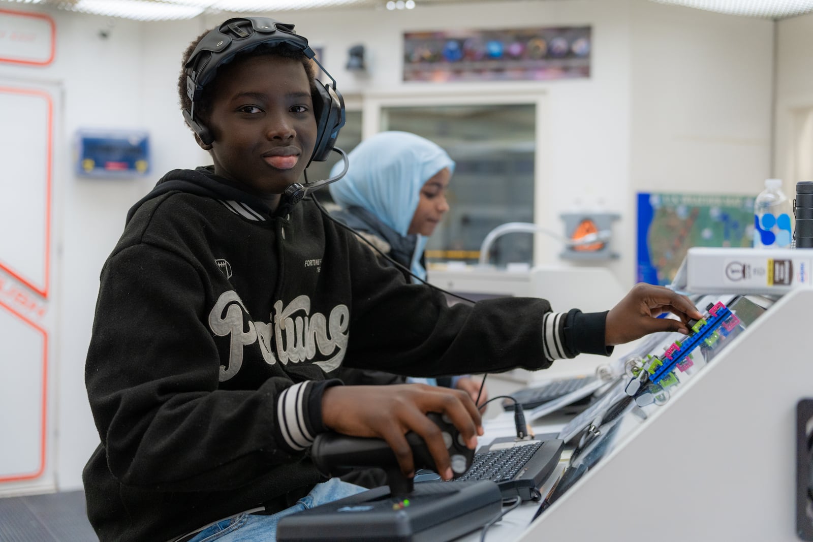 Two Kiser Elementary students navigate from inside the space shuttle at the Challenger Learning Center. In the latest mission, called "Expedition to Mars," students land on Mars and embark on a quest to find water, explore the planet, and look for signs of life. CONTRIBUTED