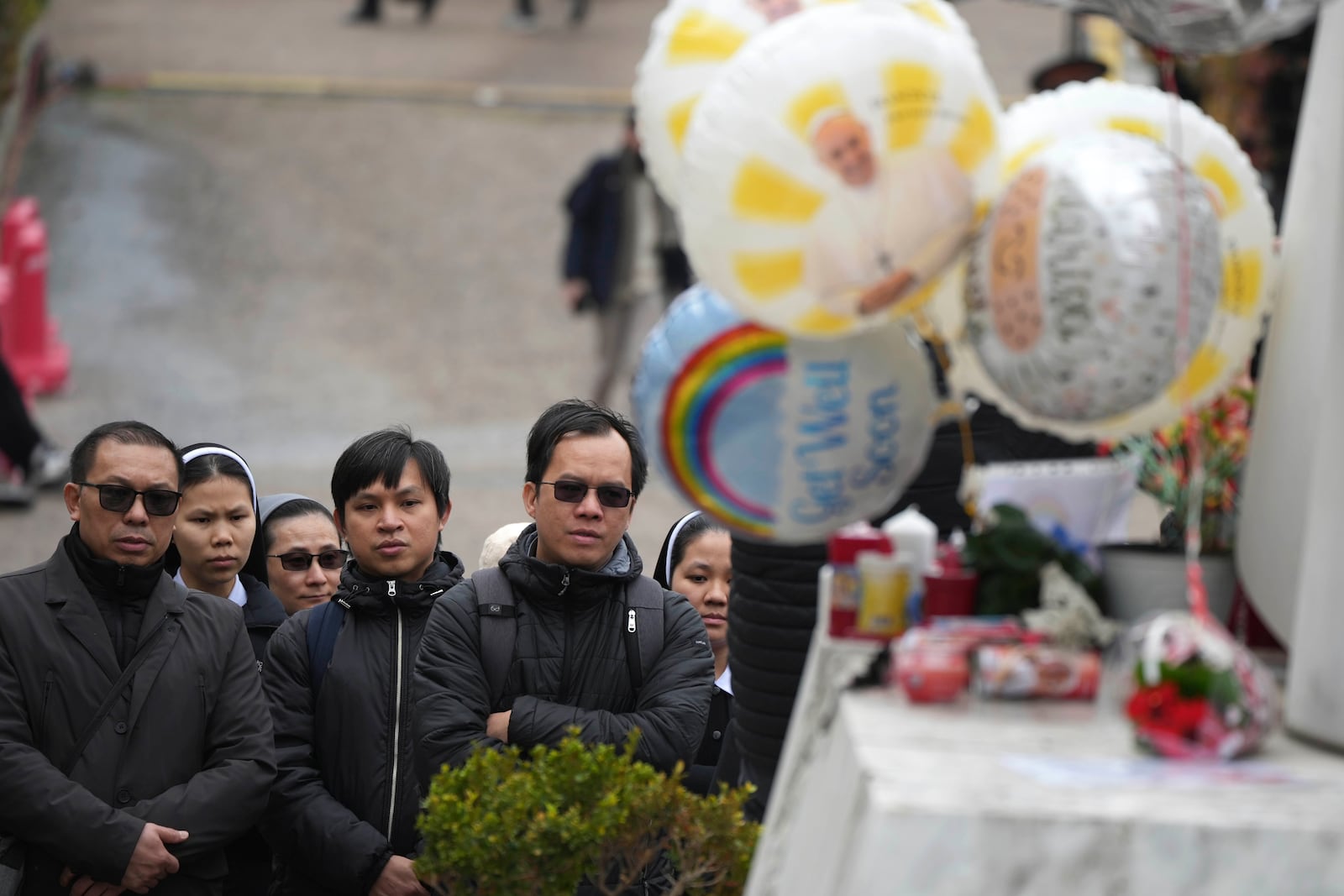 Vietnamese faithful pray at Agostino Gemelli Polyclinic, in Rome, Tuesday, Feb. 25, 2025 where Pope Francis is hospitalized since Friday, Feb. 14. (AP Photo/Alessandra Tarantino)