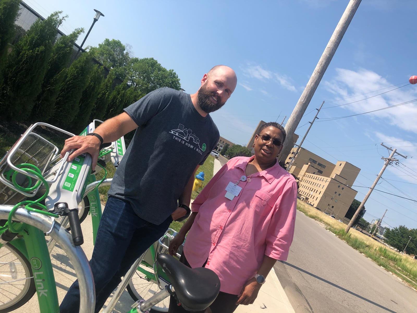 Bike Miami Valley business development manager Chris Buck gets OneFifteen therapist Yolanda Marvin up to speed on the Link: Dayton Bike Share system. CONTRIBUTED