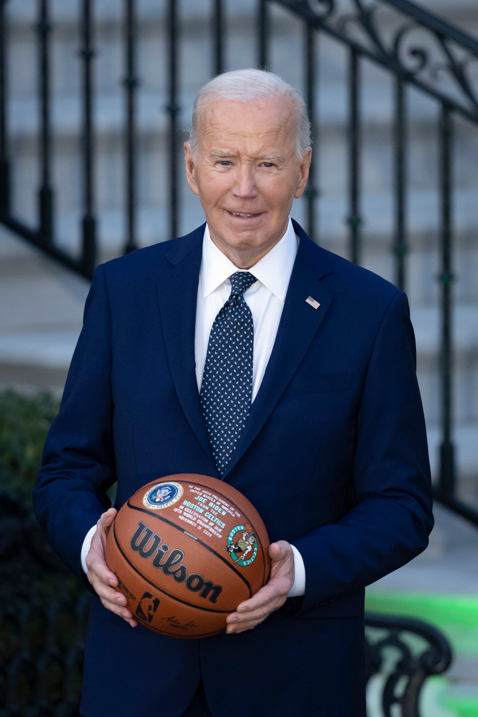 President Joe Biden holds a basketball he received from the Boston Celtics at an event to celebrate their victory in the 2024 National Basketball Association Championship, on the South Lawn of the White House in Washington, Thursday, Nov. 21, 2024. (AP Photo/Ben Curtis)