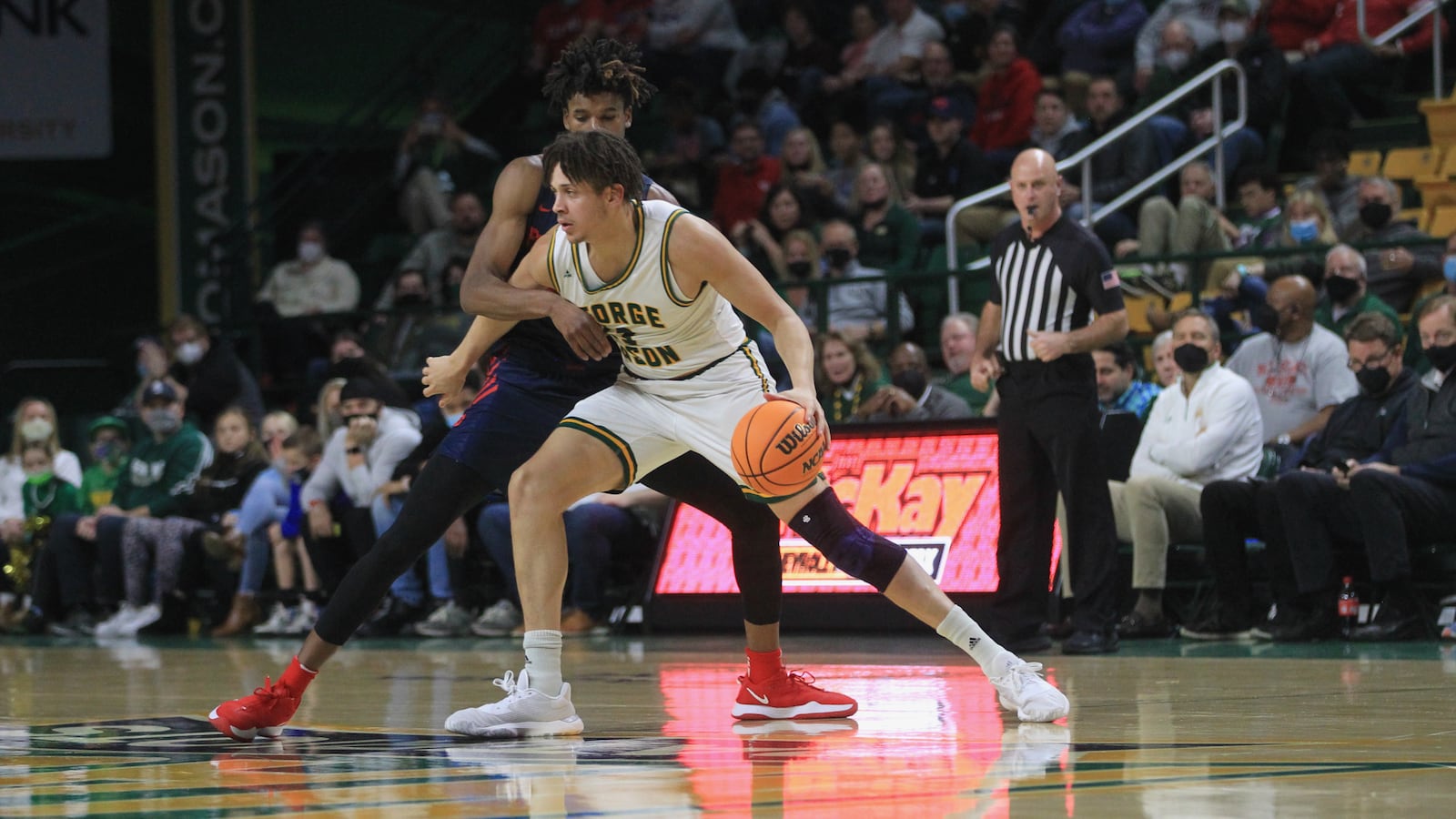 Dayton's DaRon Holmes II guards George Mason's Josh Oduro on Saturday, Jan. 22, 2022, at EagleBank Arena in Fairfax, Va. David Jablonski/Staff