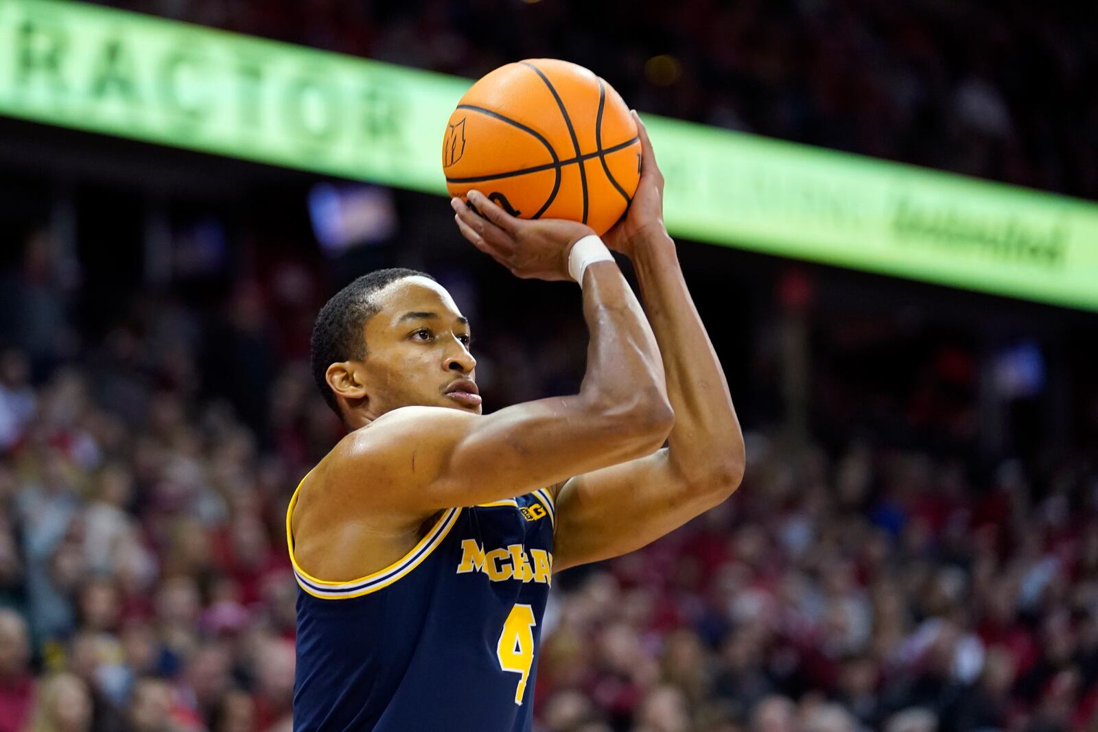 Michigan guard Nimari Burnett (4) scores a 3-point basket during the first half of an NCAA college basketball game against Wisconsin, Tuesday, Dec. 3, 2024, in Madison, Wis. (AP Photo/Kayla Wolf)