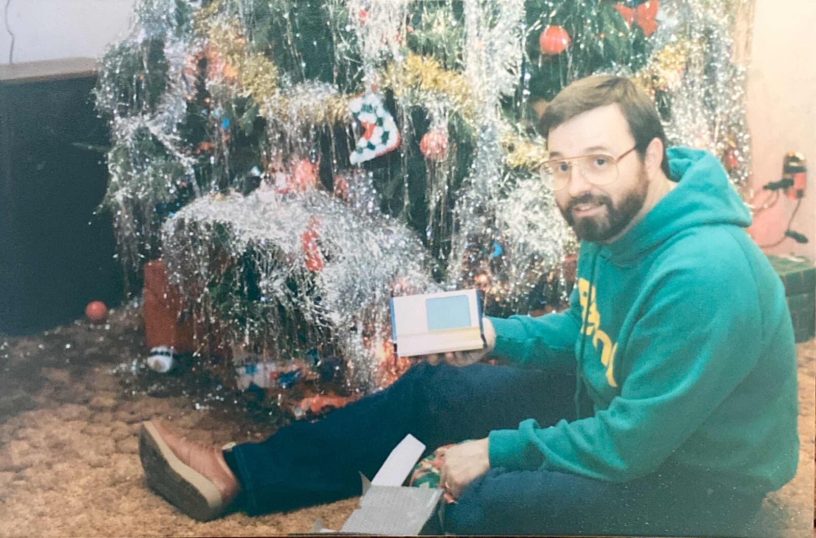 Bob LeVeck sits in front of a Christmas tree. His son, Chris LeVeck, said Christmas was his favorite time of year. CONTRIBUTED