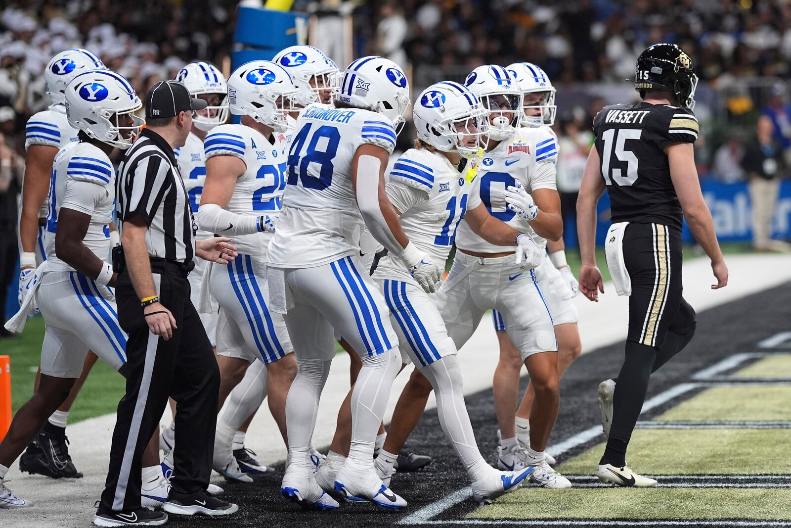 BYU wide receiver Parker Kingston (11) and teammates celebrate after he returned a punt by Colorado punter Mark Vassett (15) for a touchdown during the first half of the Alamo Bowl NCAA college football game, Saturday, Dec. 28, 2024, in San Antonio. (AP Photo/Eric Gay)