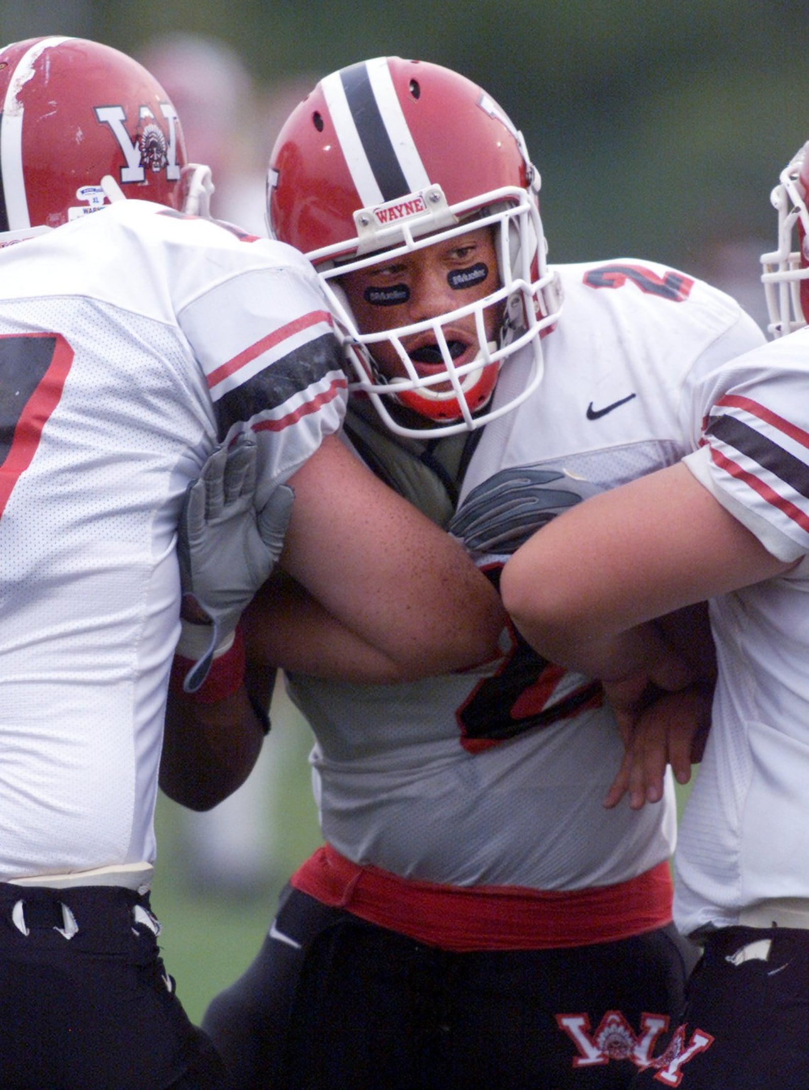 Wayne’s Marcus Freeman warms up on teammates before Friday night’s game against Centerville.