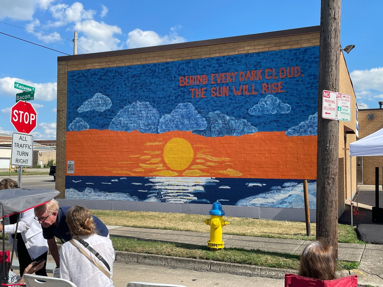 A dediction was held on June 27, 2024 for the latest suicide prevention mural, which was painted by Montgomery County Prevention Coalition volunteers and graduates of the Dayton Area Chamber of Commerce Leadership Dayton Class of 2024 with the message “Behind Every Dark Cloud, The Sun Will Rise.” A QR code embedded in the mural will direct people to mental health and recovery resources.  SAM WILDOW\STAFF