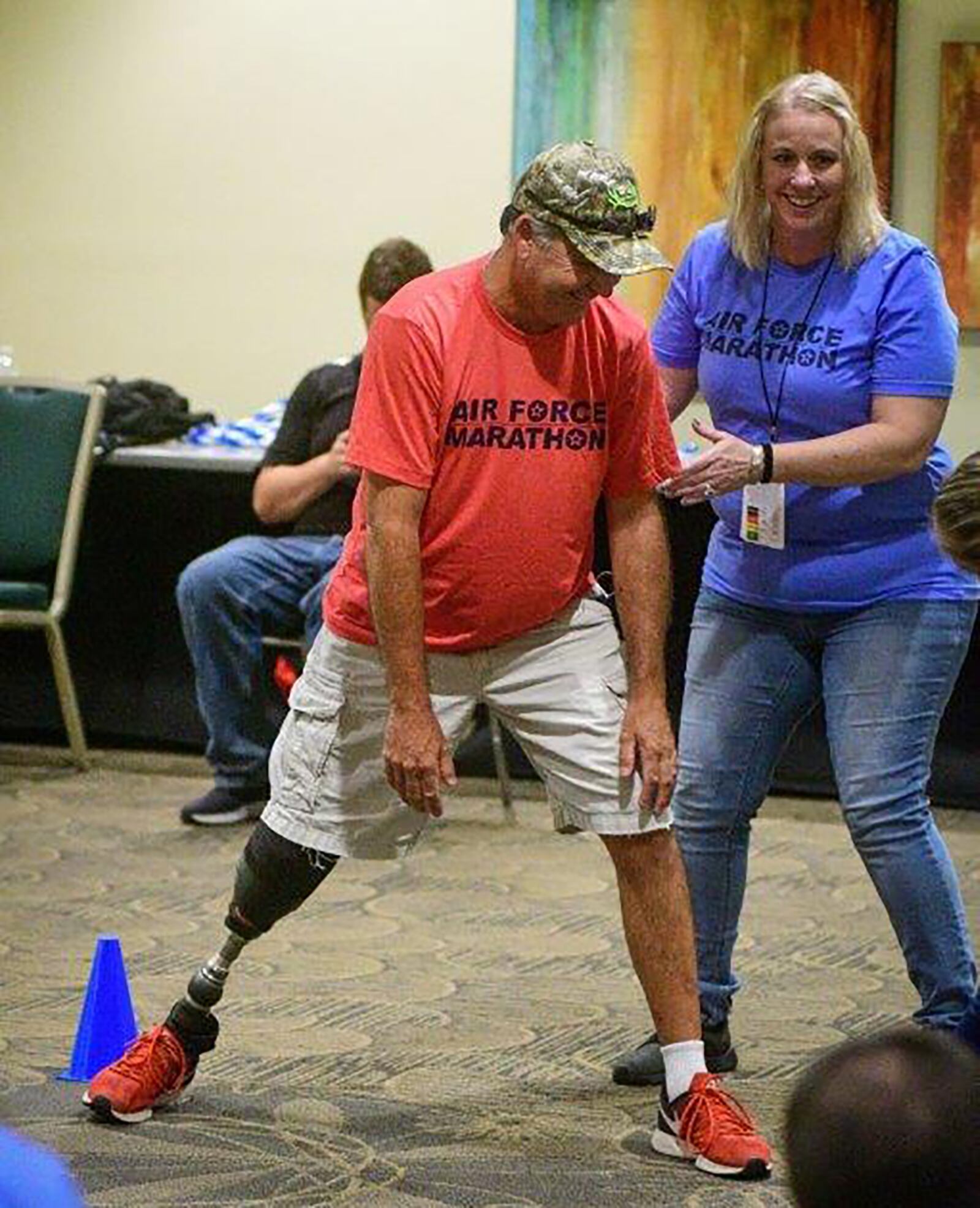 Maribeth McClure assists Doug Stone with pre-running stretches during the inaugural Amputee Mobility Clinic as part of race weekend in September 2019. CONTRIBUTED PHOTO