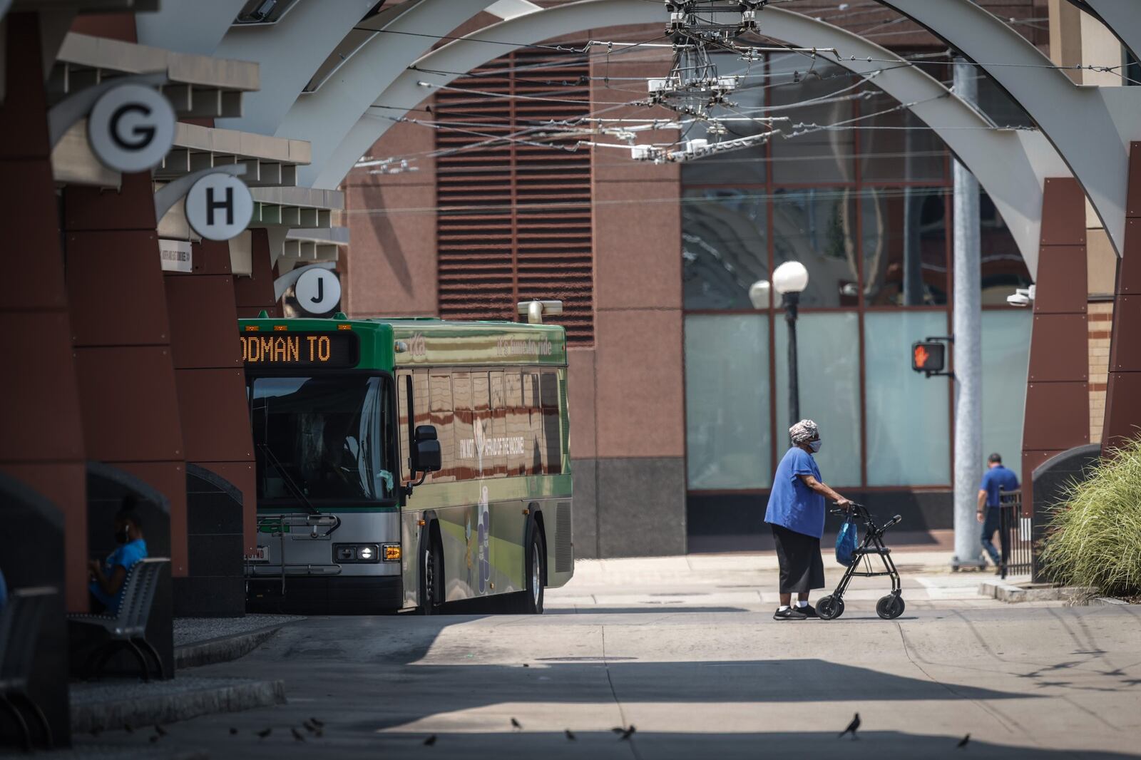 RTA riders depart and load onto buses at the RTA Hub on Main St. in Dayton Tuesday July 27, 2021. RTA is moving to a cashless system in November. About one in five riders use cash. A survey shows nearly half of the riders earn $15k or less and 92% don't have access to a vehicle. JIM NOELKER/STAFF