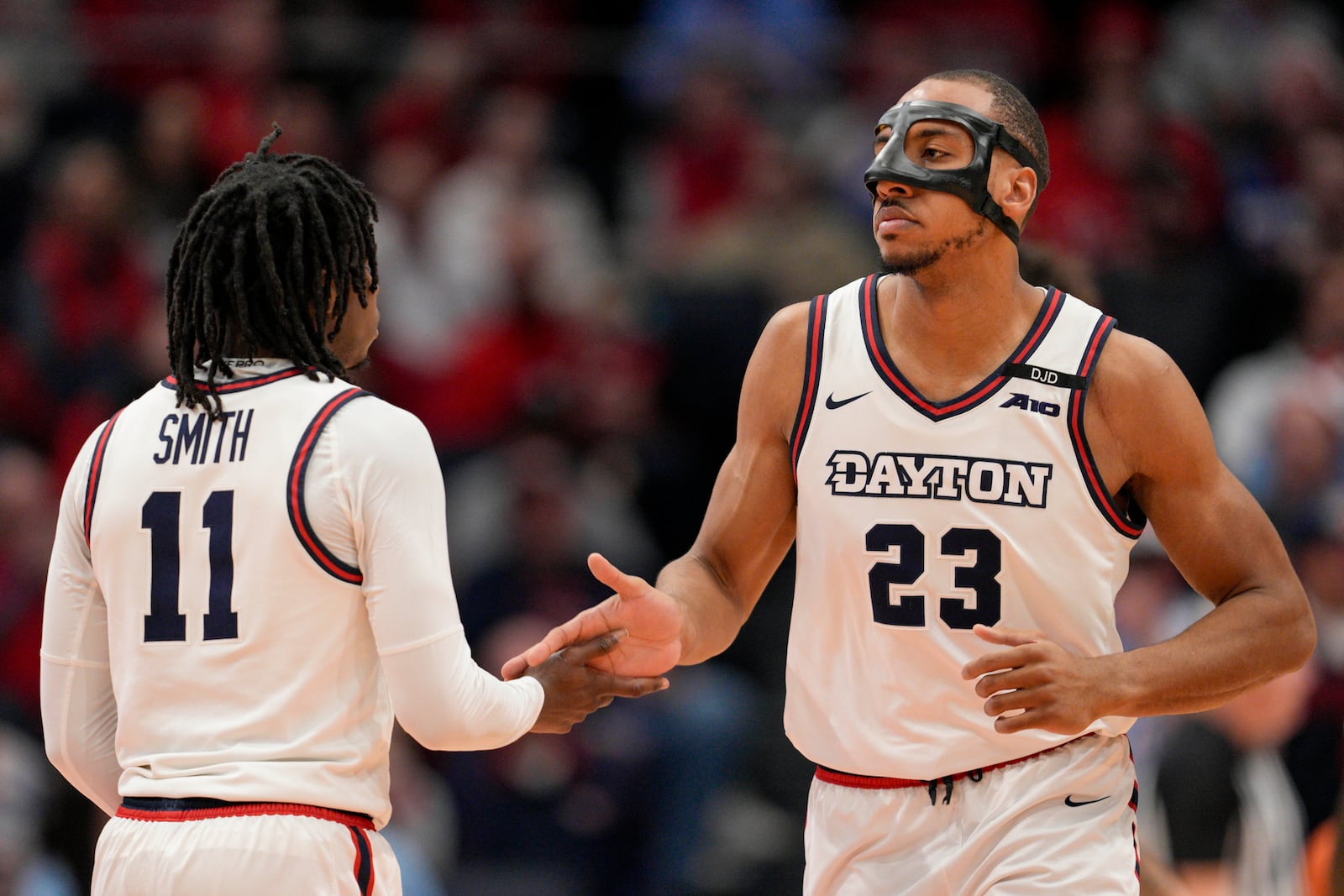 Dayton's Zed Key (23) celebrates with teammate Malachi Smith (11) during the first half of an NCAA college basketball game against UNLV, Tuesday, Dec. 17, 2024, in Dayton, Ohio. (AP Photo/Jeff Dean)